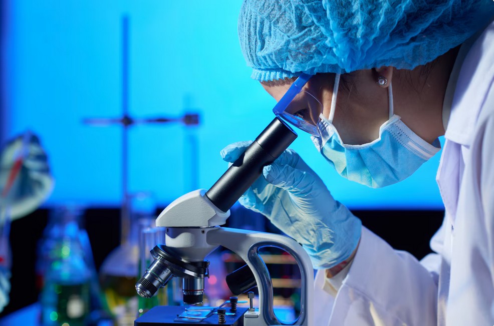 Biotechnology Translation Services researcher examining a sample under a microscope