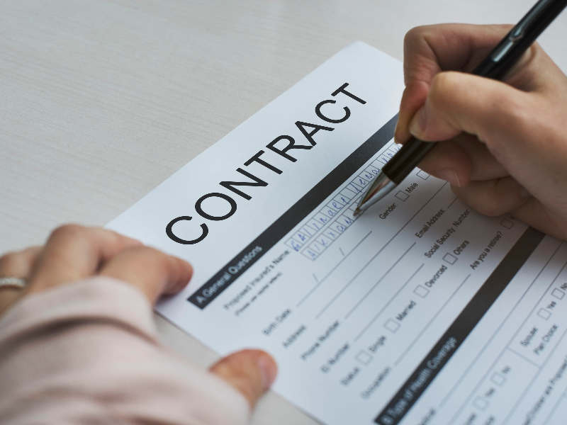The Ultimate Guide to Mastering Global Legal Translation Services. aperson signig a contract