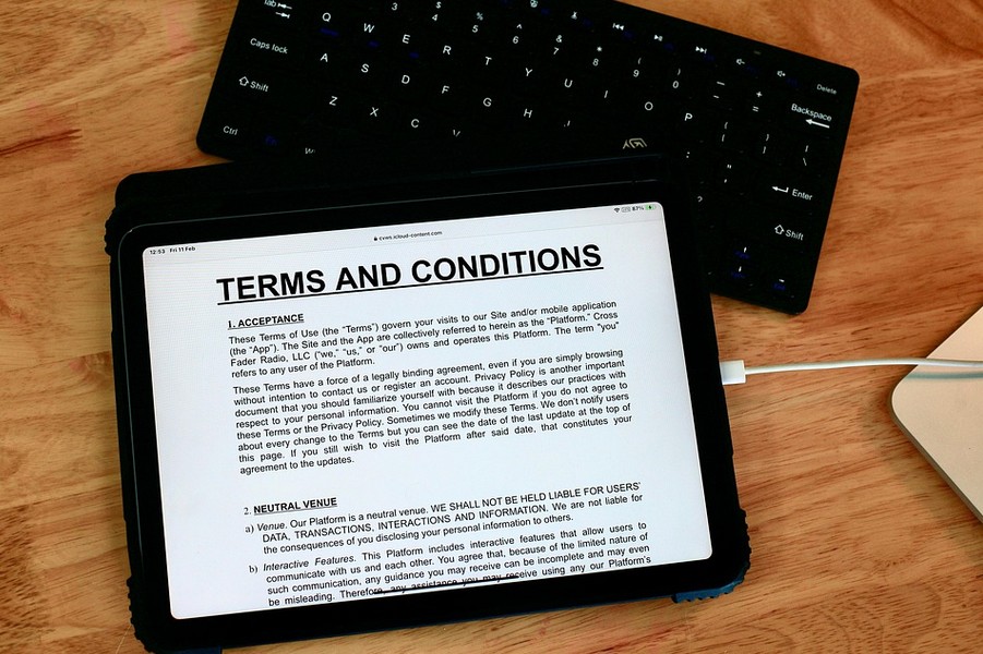 The Ultimate Guide to Mastering Global Legal Translation Services. a tablet showing terms and conditions text