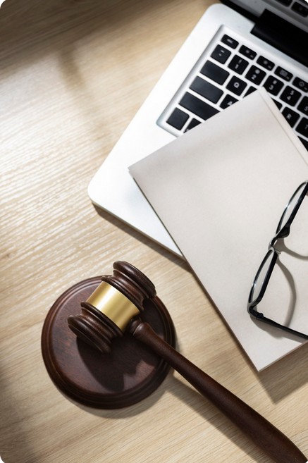 The Ultimate Guide to Mastering Global Legal Translation Services. image showing a judge gavel with paper and laptop
