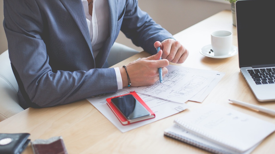 Beyond the Buzzwords: How to Evaluate a World-Class Medical Device IFU Localization Case Study. a person on work table with a laptop and smartphone in front of