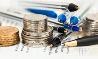 Transcreation vs. Translation: The Ultimate Guide for Fintech Marketing. pens and coins on banking sheets