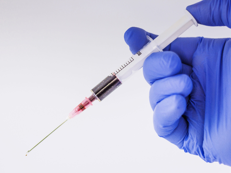 Beyond Terminology: Expert Translation for Your Most Critical Life Science Documents. a hand holding a medical injection