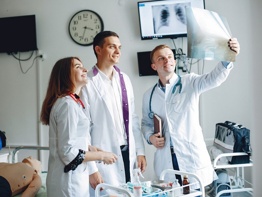 Beyond Terminology: Expert Translation for Your Most Critical Life Science Documents. a group of doctors examining an X-ray