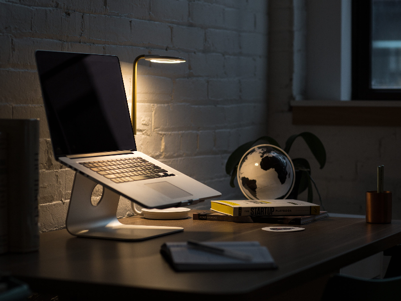 Your 2025 Guide to Financial Translation: How to Get Top Quality Without the Top Price. worktable with laptop and glob model on it