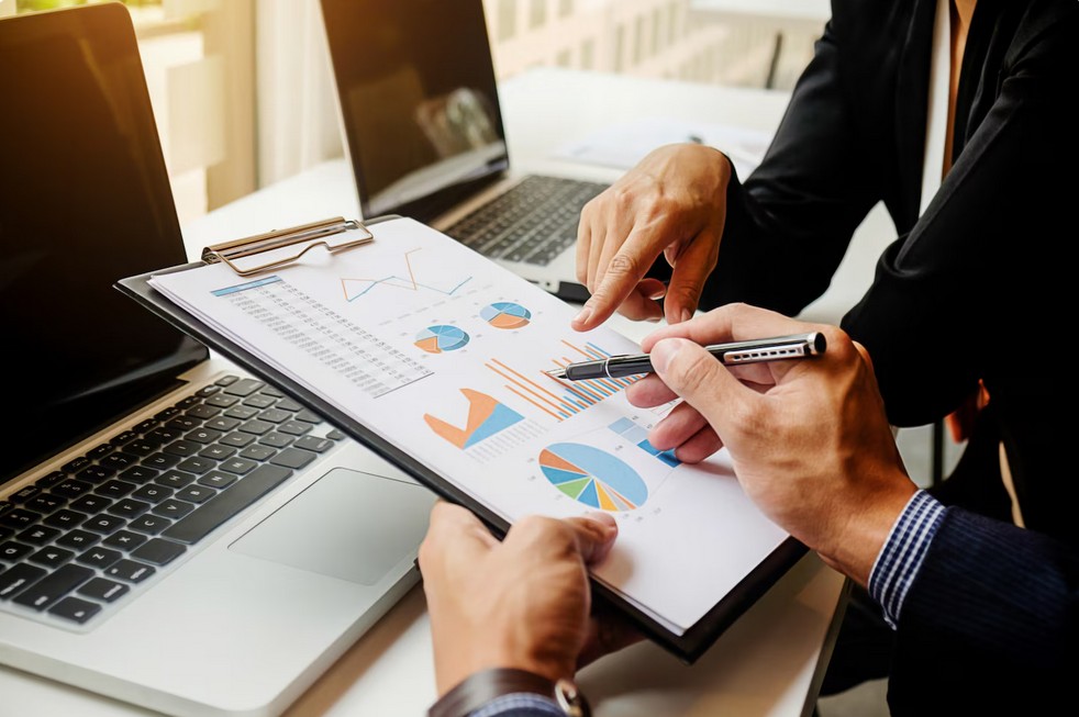 Catastrophe Averted: The Ultimate Guide to Financial Regulation Translation Compliance. employees checking a financial blue print