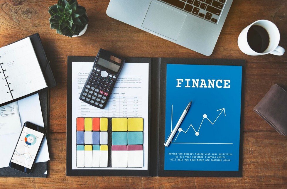 Catastrophe Averted: The Ultimate Guide to Financial Regulation Translation Compliance. image showing financial document with calculator, smartphone and laptop