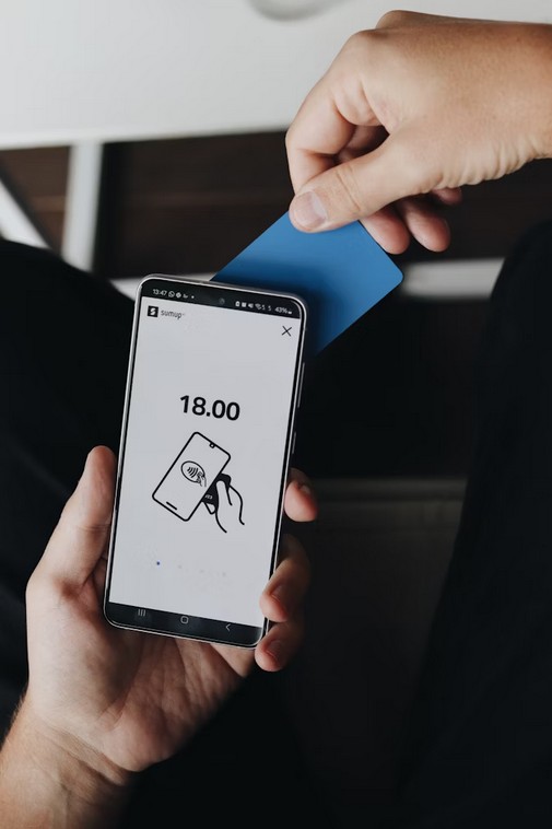 Unleash Asia: The Ultimate Guide to Fintech App Localization. a person using his phone to make a payment