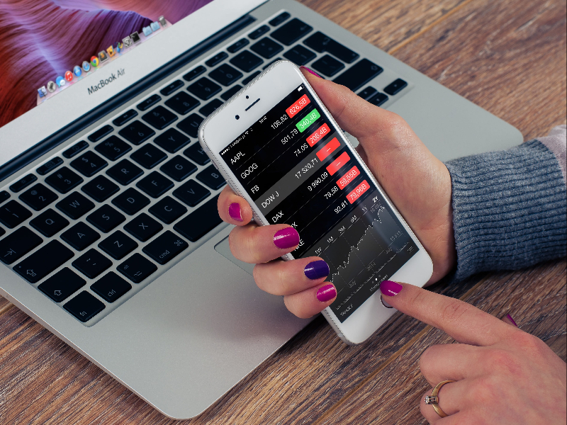The Fintech & Blockchain Dictionary: What You Need to Know (And What They Won't Tell You). a person checking a smartphone displaying banks data