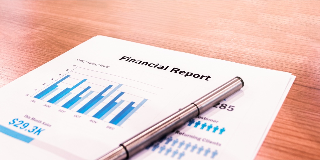 sheets with banking data, and a pen on them