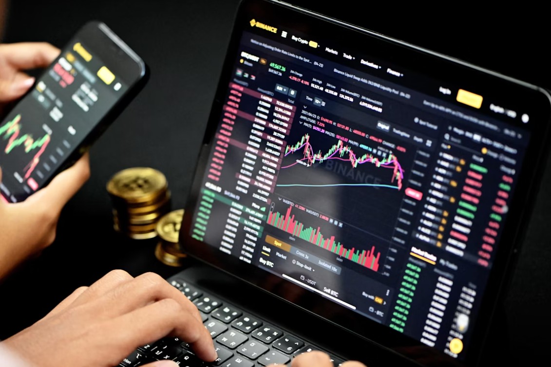 One Wrong Word: The Peril of Amateur Crypto Translation. person working at laptop and checking cybercurrency data on a smartphone
