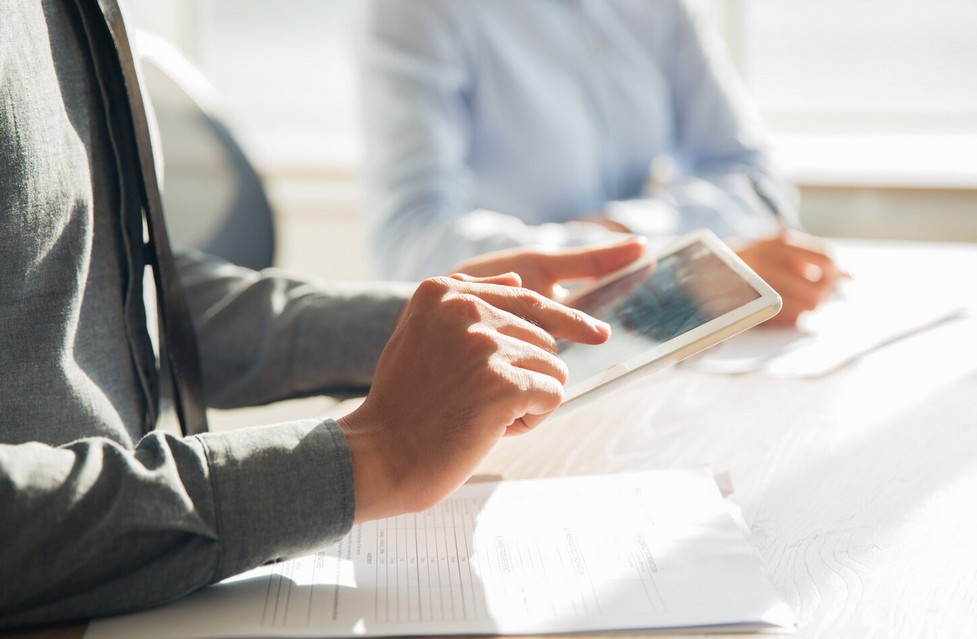 Eliminate Regulatory Risk: Secure Your Approval in the U.S., Europe, and Japan. a pesrson touching a tablet screen