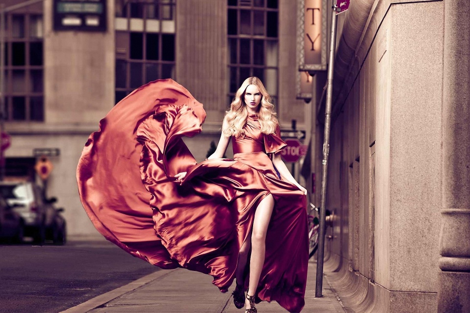 Architects of Aspiration: The Hidden Force Behind Global Fashion Trends. a woman is modeling a new dress