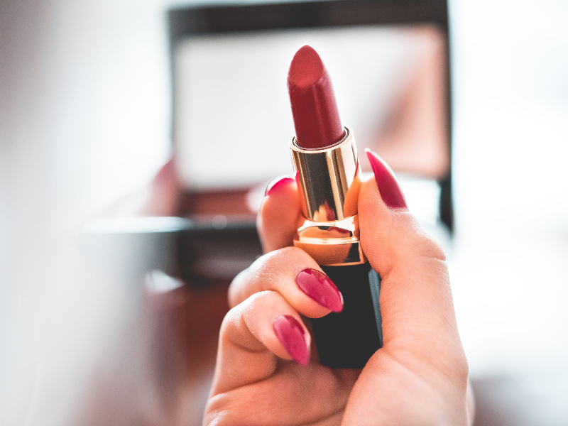 The Art of Translation: Unlocking New Markets for the Global Beauty Industry. a woman holding a lipstick.