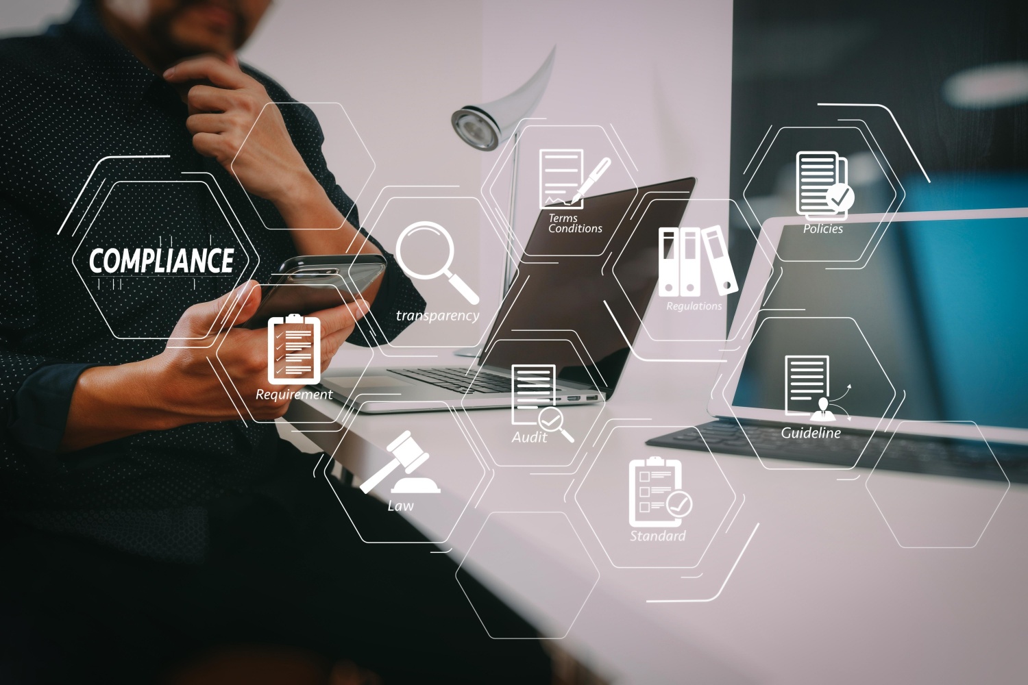 a n employee working at a laptop and avirtual screen displays quality icons