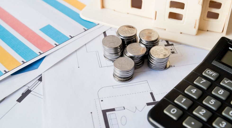 The Hidden Cost of Ambiguity: 5 Real-World Financial Translation Disasters. image showing calculator, coins, and financial papers