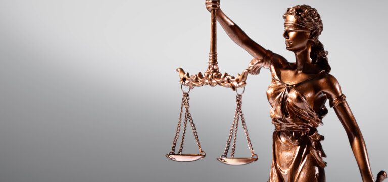 Image showing a judge's gavel with a statue of Blind Justice holding the scales of justicث