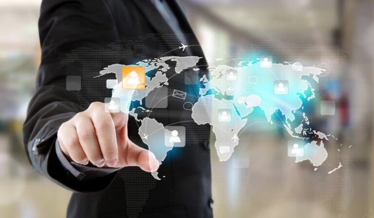 a man touches a virtual screen which displays the world map