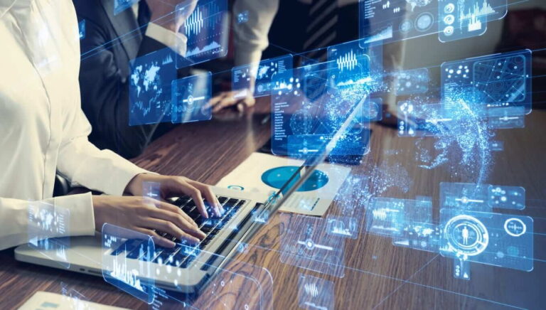 a man working on a laptop and data is disolayed on a virtual screen