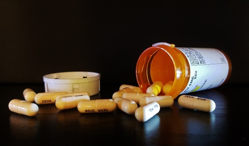 an image showing a pill can and medicine pills