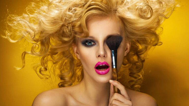 a woman holding a cosmotics brush
